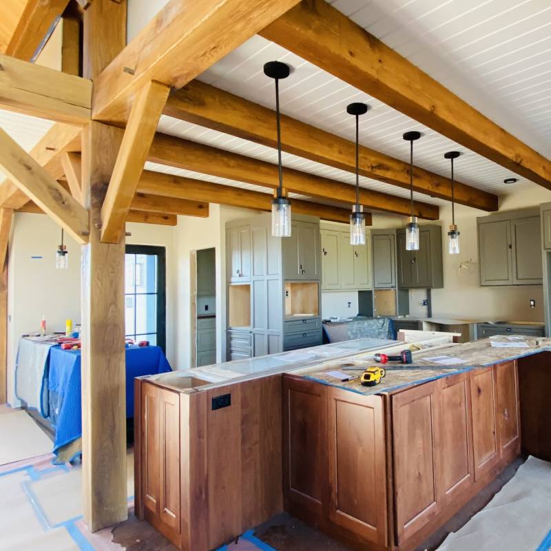 a kitchen with wood beams and wood cabinets